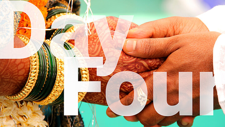 Abstract graphic of large "Day Four" text and hands of an Indian couple on their wedding day in the background.